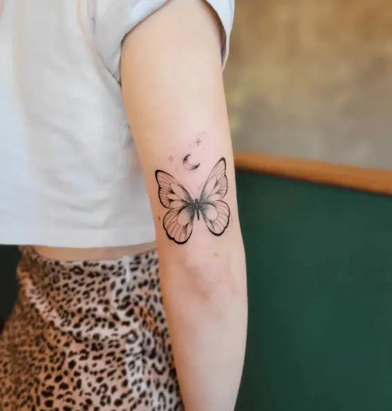 Black Ink Butterfly with Moon and Stars Tricep Tattoo