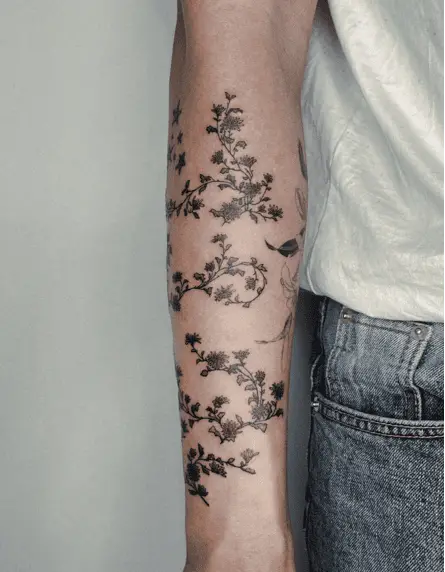 Black Wild Chrysanthemum Flowers Wrapped Around the Arm Tattoo