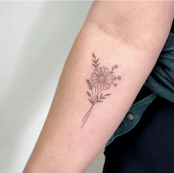 Fine Line Daisy With Some Small Wildflowers Arm Tattoo
