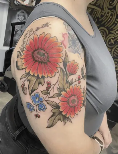 Colored Two Big Blanket Flowers With Some Wildflowers Upper Arm Tattoo