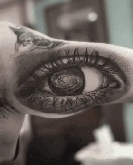 Realistic Close Up Stars in an Eye Upper Arm Tattoo