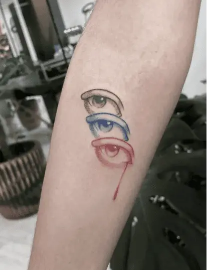 Colored Triple Eye With One Teary Eye Arm Tattoo