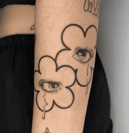 Black Work Two Crying Eyes in Outline Flower Arm Tattoo