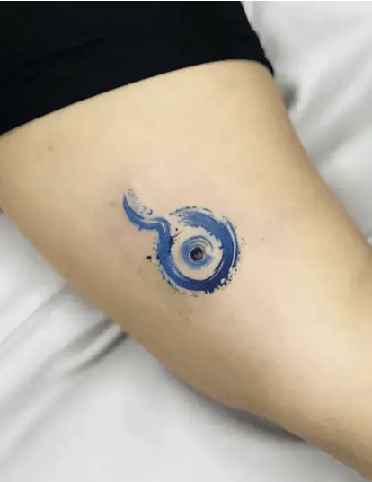 Blue Water Surrounding the Evil Eye Upper Arm Tattoo