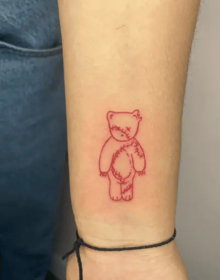 Red Ink Damaged Teddy Wrist Tattoo
