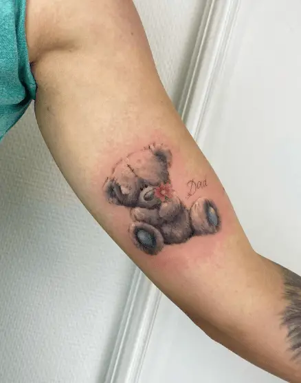Grey and Blue Teddy with Red Flower Arm Tattoo