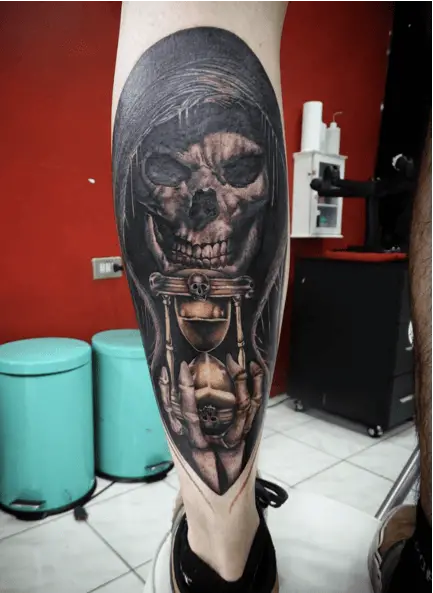 Gold Hourglass Held by a Grim Reaper Tattoo
