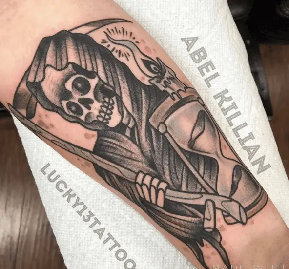 Candle on Top of the Hourglass Being Held by the Grim Reaper Tattoo