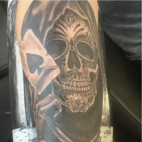 Grim Reaper Face Tattoo Holds an Ace of Spades Near His Eye Tattoo