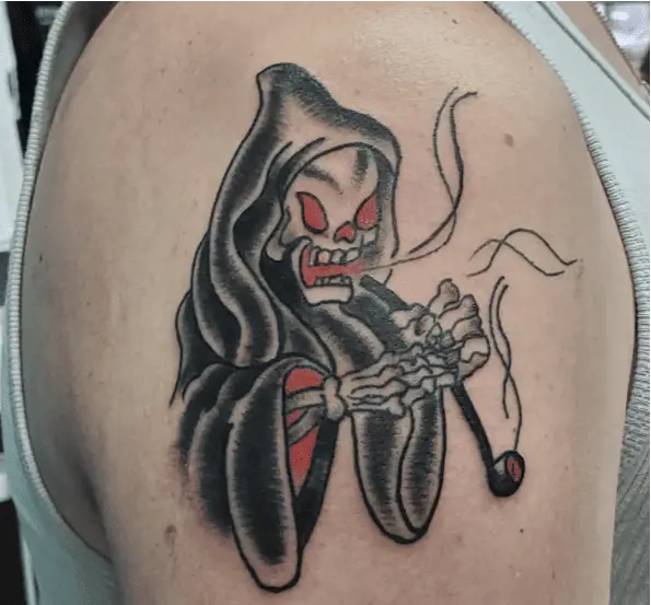 A Grim Reaper With Gold Tooth Smoking a Tobacco Pipe Tattoo