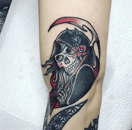 Female Grim Reaper Flower Behind Her Ear Tattoo