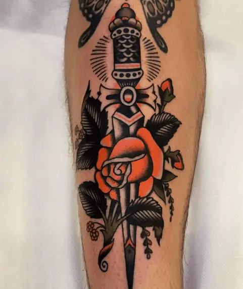 Black and Orange Traditional Rose and Dagger Tattoo