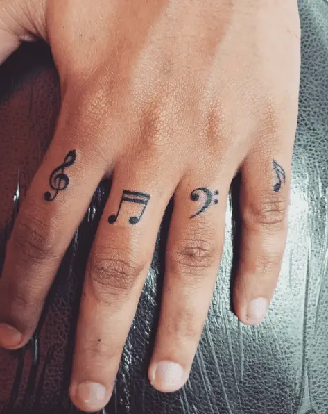 Multiple Music Symbols Finger Tattoo