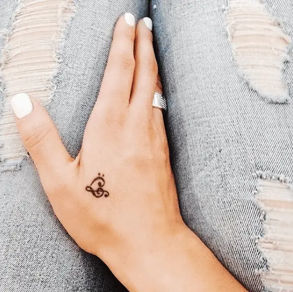 Tiny Heart Shaped Music Note Hand Tattoo