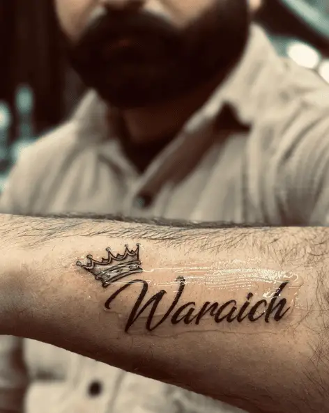 Surname with Crown Forearm Tattoo