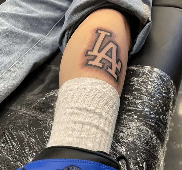 Embossed Style "LA" Lettering Leg Tattoo
