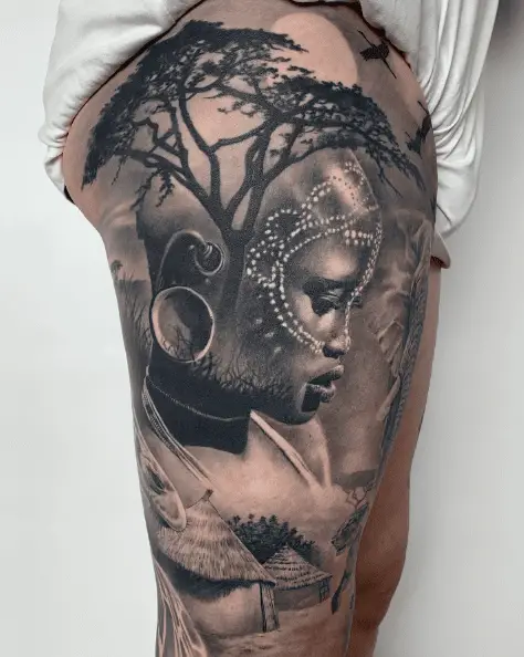 African Woman with Trees and Mudhouse Thigh Tattoo