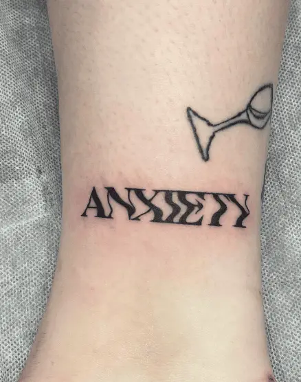 Smudged Anxiety Lettering Tattoo