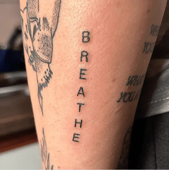 Black Ink Breathe Lettering Tattoo