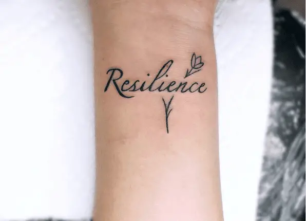 Black Ink Resilience Text with Tiny Rose Wrist Tattoo