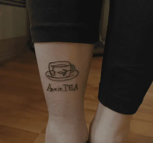 Cup and Saucer with Anxie.TEA Leg Tattoo