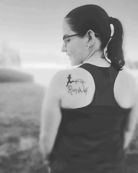 Running Woman with Heartbeat and "Run Wild" Lettering Tattoo